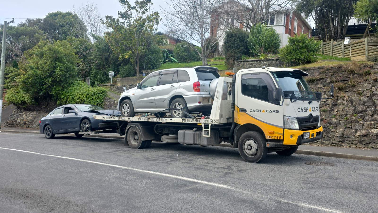 Cash 4 Cars truck towing an SUV and a sedan in Southland